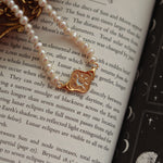 the gold pendant with pearl chain 