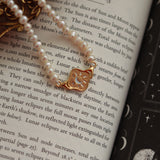 the gold pendant with pearl chain 